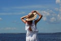 Tanned woman in white dress and hat on riverside Royalty Free Stock Photo