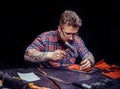Tanner of leather creates a new leatherwork at the leather studio Royalty Free Stock Photo