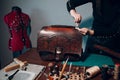 Tanner woman making leather goods on workshop. Working process of leather craftsman Royalty Free Stock Photo