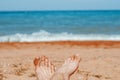 women's feet on the beach by the sea Royalty Free Stock Photo