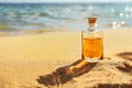 Tanning oil on sandy beach with copyspace area