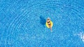 Tanning in a pool. Woman relax in the pool in sunny day in yellow inflatable ring Royalty Free Stock Photo