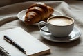 Cozy Breakfast Setup: Croissant, Coffee, and Journal Royalty Free Stock Photo