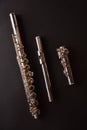 Tansverse flute unmounted into three parts on black table vertical Royalty Free Stock Photo