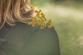 Tansy flowers on a woman`s shoulder in the rays of the setting sun Royalty Free Stock Photo