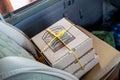 Boxed lunches prepared by a lodge for safari guests sitting on the front eat of a car to eat