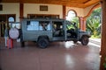 Land Cruiser safari vehicle being loaded with passengers luggage prior to leaving the lodge to