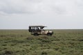 Safari vehicle Land Cruiser takes tourists on a game drive in Serengeti National Park