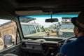 Traffic jam of safari vehicles and Toyota Land Cruisers as tourists watch a lion in the