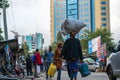 TANZANIA, ARUSHA - 15 Jan 2020: Carry good on the head is african skill. People on the street in Arusha city, Tanzania