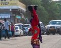 TANZANIA, ARUSHA - 15 Jan 2020: Carry good on the head is african skill. People on the street in Arusha city, Tanzania