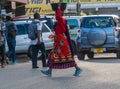 TANZANIA, ARUSHA - 15 Jan 2020: Carry good on the head is african skill. People on the street in Arusha city, Tanzania