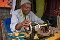 TANZANIA, MASAI VILLAGE - JANUARY 2020: Portrait of Sewer of Swiss Tailor Maasai man working With sewing machine in