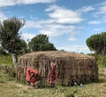 Tanzania - Masai women building a new mud house in Sukenya.