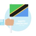 Tanzania Union Day, 26 april celebration card with hand holding tanzanian flag.