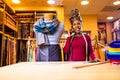 tanzanian woman with snake print turban over hear working in fabrics shop calling to client by smartphone