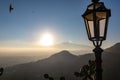 Taormina - Close up view on lantern with panoramic view on volcano Mount Etna from the rooftops of Taormina, Sicily, Italy,