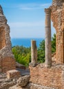 Ruins of the Ancient Greek Theater in Taormina with the sea in the background. Province of Messina, Sicily, southern Italy. Royalty Free Stock Photo