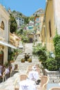 TAORMINA, ITALY - JUNE 20, 2019: cozy flight of steps with typical Italian restaurant in Taormina, Sicily