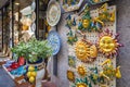 Typical Sicilian Souvenir in ceramic symbolising the sunshine and triskelions - symbol of Sicily Royalty Free Stock Photo