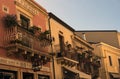 Vintage houses with beautiful decorated balconies by blooming potted flowers, succulents and cacti in Taormina. Sicily Royalty Free Stock Photo