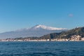 Taormina - Panoramic view from open sea on snow capped volcano Mount Etna in Taormina, Sicily, Italy, Europe, EU. Royalty Free Stock Photo