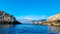 Taormina - Panoramic view from open sea on snow capped volcano Mount Etna in Taormina, Sicily, Italy, Europe, EU. Royalty Free Stock Photo