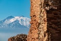 Taormina - Panoramic view of snow capped Mount Etna volcano seen from the ancient Greek theatre of Taormina, island Sicily, Italy Royalty Free Stock Photo