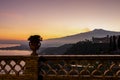 Taormina - Scenic view on snow capped Mount Etna volcano during sunset from public garden Parco Duca di Cesaro in Taormina Sicily Royalty Free Stock Photo