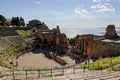 Wide-angle shot of Teatro Antico di Taormina Ancient Amphitheatre in Sicily, Italy during sunny day with sea in the background Royalty Free Stock Photo