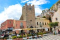 Taormina, Sicily, Italy - Apr 8th 2019: People sitting in outdoor restaurants and cafes on beautiful Piazza IX Aprile square