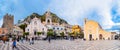 Taormina, Sicily, Italy - Apr 05, 2023: tourists walking on main square or Piazza IX Aprile with San Giuseppe church Royalty Free Stock Photo