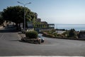 Cars moving on road at ancient coastal city with sky in background during summer Royalty Free Stock Photo