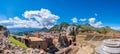 Taormina on Sicily, Italy. Ruins of ancient Greek theater, mount Etna covered with clouds. Taormina old town and Royalty Free Stock Photo