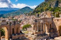 Taormina on Sicily, Italy. Ruins of ancient Greek theater, mount Etna covered with clouds. Taormina old town and Royalty Free Stock Photo