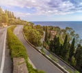 Taormina, Sicily - The streets of the famous hilltop town of Taormina with palm tree, mediterranean sea
