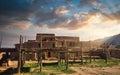 Taos Pueblo Illuminated by the Morning Sun over the Sangre de Cristo Mountains in New Mexico Royalty Free Stock Photo