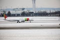 TAP Air Portugal plane on runway in Munich Airport, Germany, Winter time with snow Royalty Free Stock Photo