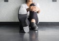 Tap dancer sitting down in tap class holding one of her legs Royalty Free Stock Photo