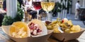 Tapas bar panorama. Cheese, ham and pinchos with red and white wine on a wooden table Royalty Free Stock Photo