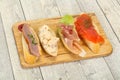 Tapas - bruschetta with prosciutto, salmon, duck and gorgonzola Royalty Free Stock Photo