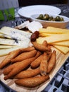 Tapas, homemade snack of blue cheese selection, bread sticks and olives