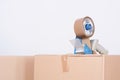 Tape dispenser sealing a shipping cardboard box Royalty Free Stock Photo