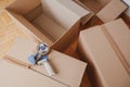 Tape dispenser sealing a shipping cardboard box Royalty Free Stock Photo