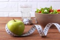 tape and lettuce on a light background. Slimming, diet, healthy food. Royalty Free Stock Photo