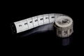 Tape measeure on black background Royalty Free Stock Photo