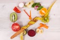 Tape measue with fruits and vegetables in shape of clock showing time to healthy eating and slimming