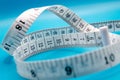 Close up of tape measure on a blue background Royalty Free Stock Photo