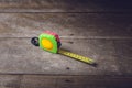 Tape measure on the brown wooden background Royalty Free Stock Photo