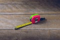 Tape measure on the brown wooden background Royalty Free Stock Photo